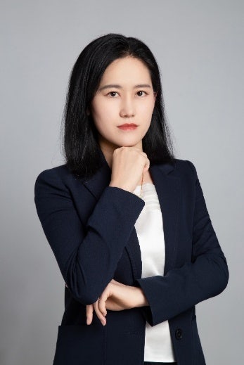 A picture containing person, wall, clothing, suit Description automatically generated